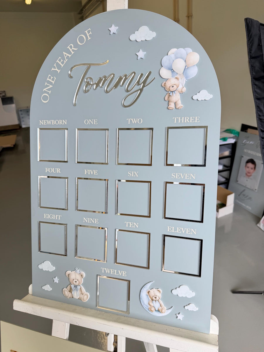 Custom first birthday photo board with teddy bear theme and milestones.