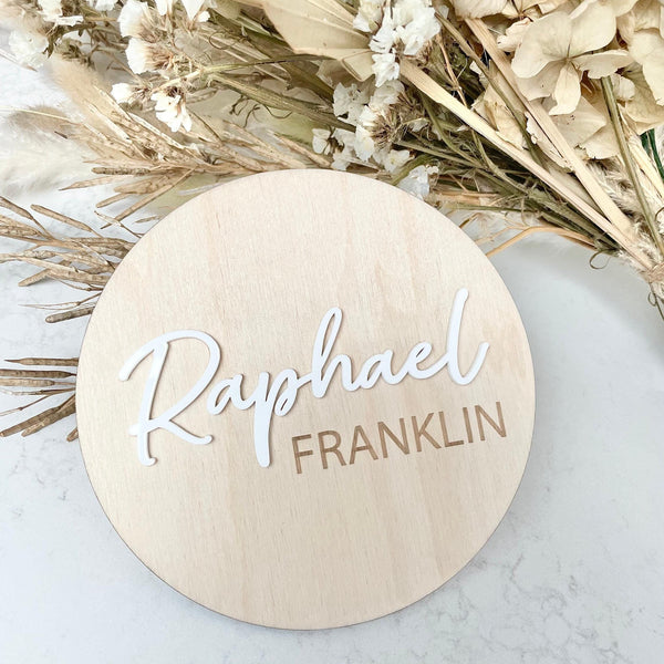 Personalised wooden birth announcement disc with custom name in natural wood