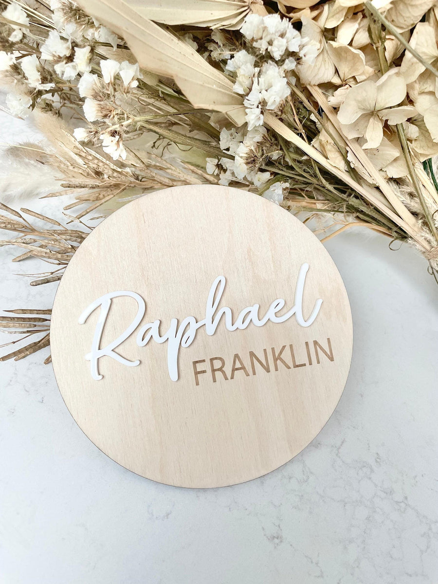 Personalised wooden birth announcement disc with custom name in natural wood