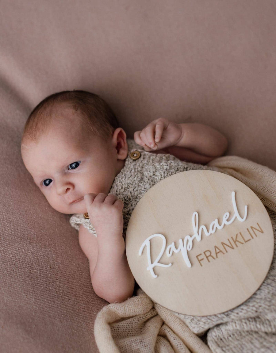 Personalised wooden birth announcement disc with engraved name, round shape