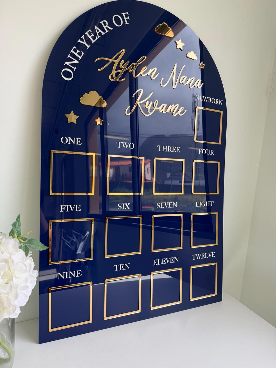 Custom first birthday photo board with stars and clouds design.