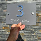 Custom acrylic house sign in clear material with modern stand-offs