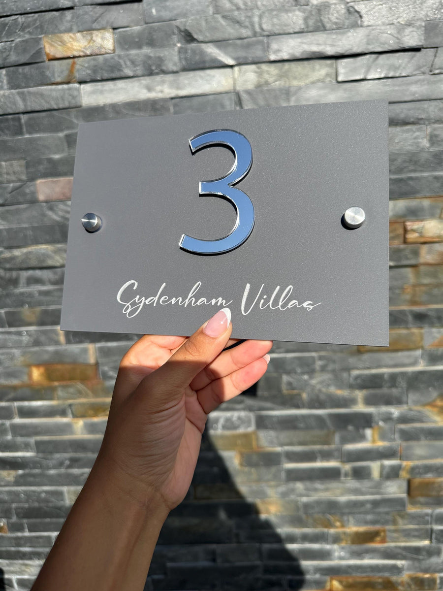 Custom acrylic house sign in clear material with modern stand-offs