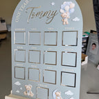 Custom first birthday photo board with teddy bear theme and milestones.