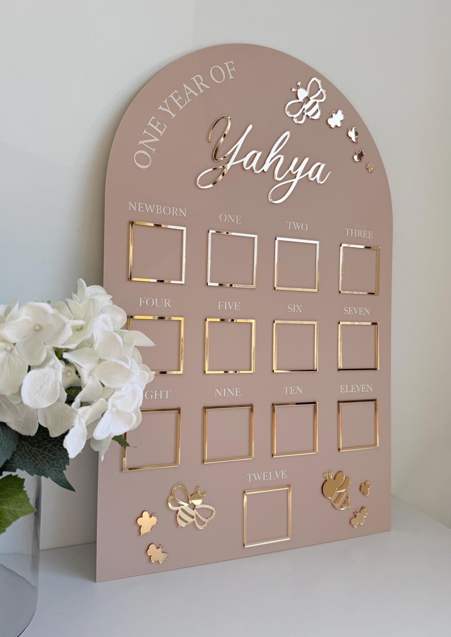 Custom first birthday photo board in bumblebee theme with milestone photos