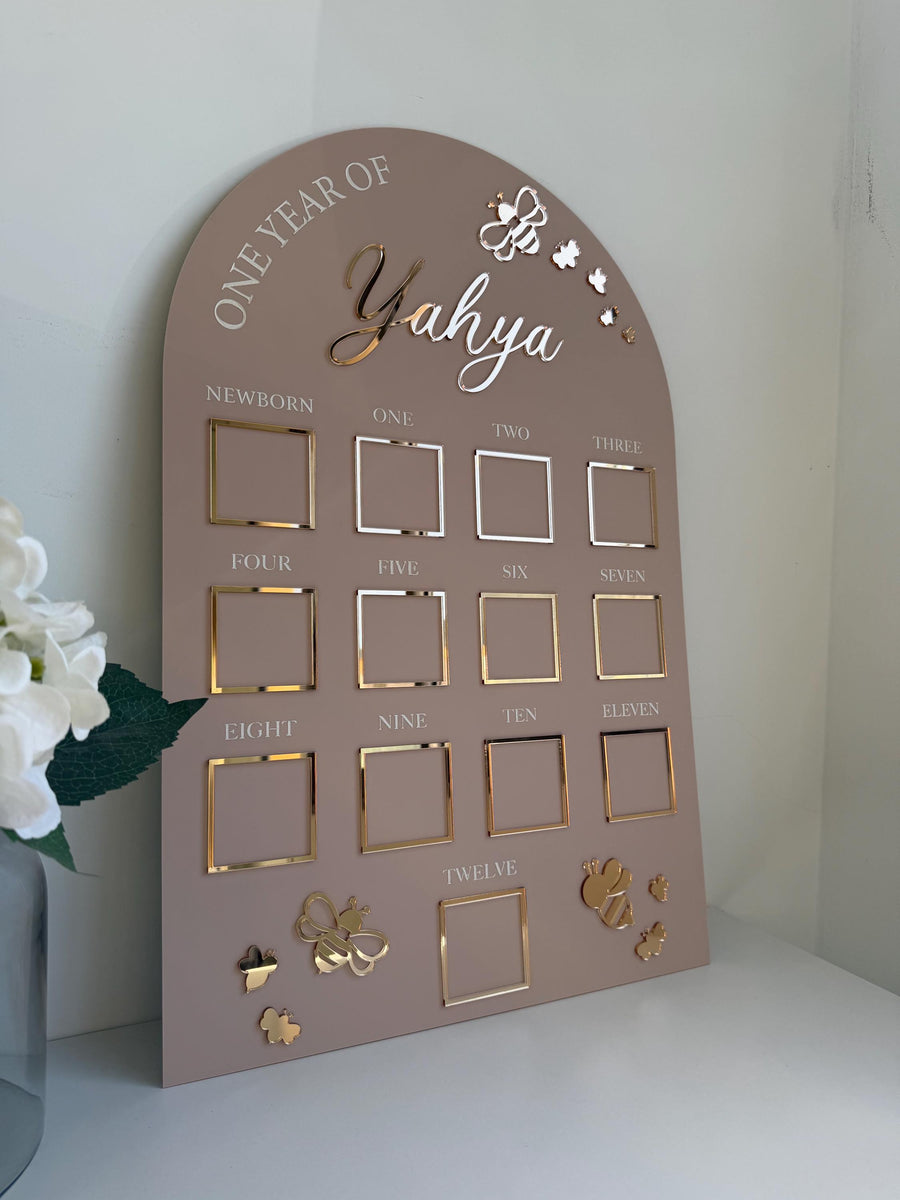 Custom first birthday photo board in bumblebee theme with milestone photos