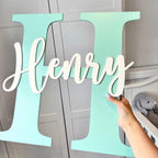 Custom initial and name wooden wall plaque in light wood, modern nursery decor