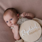 Personalised wooden birth announcement disc with engraved name, round shape