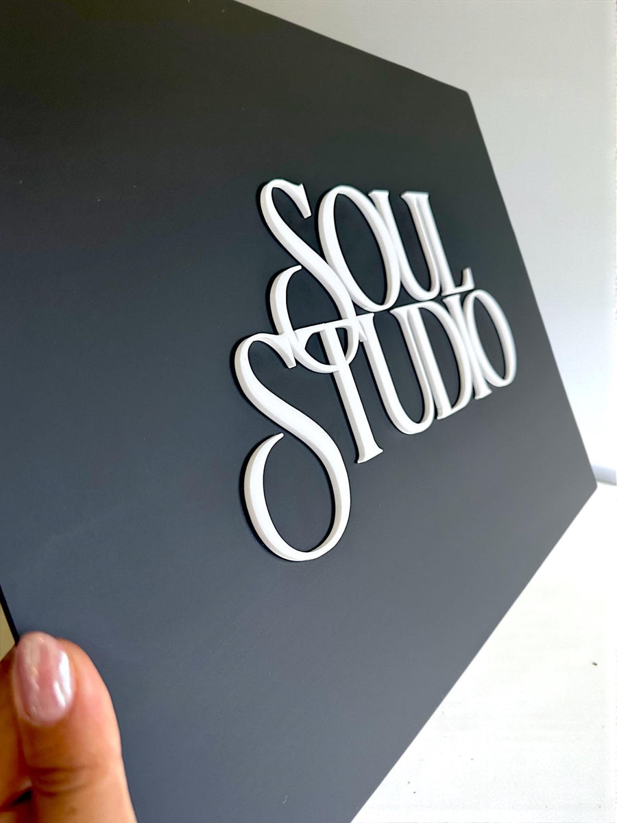 Minimalist business logo sign in sleek black for office reception.