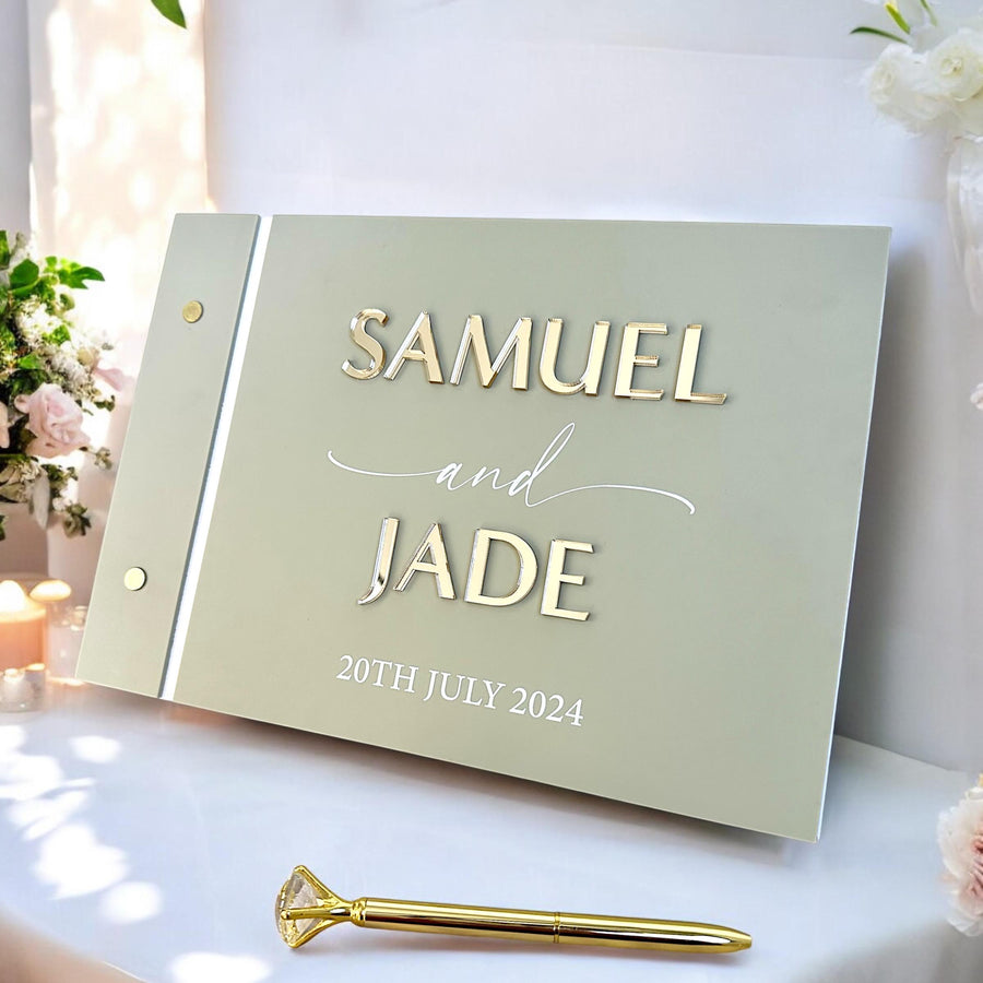 Custom acrylic wedding guestbook with crystal pen on a decorative table