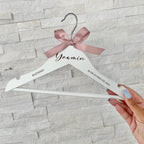 Personalised baby hanger in light wood with engraved name detail